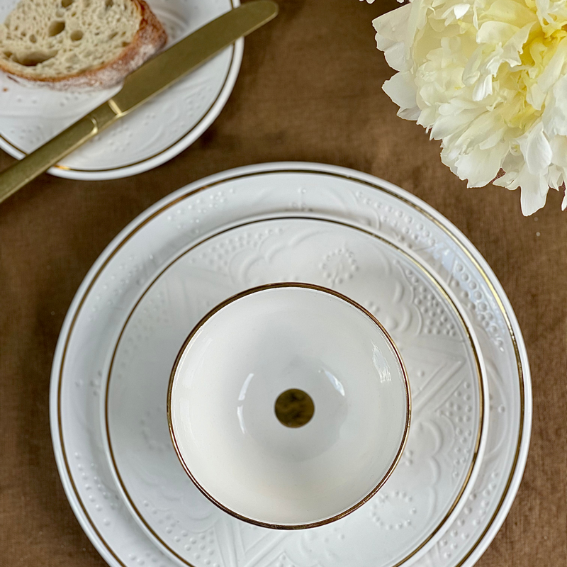 dinner setting with white and gold ceramic plates and bowls by Chabi chic morocco