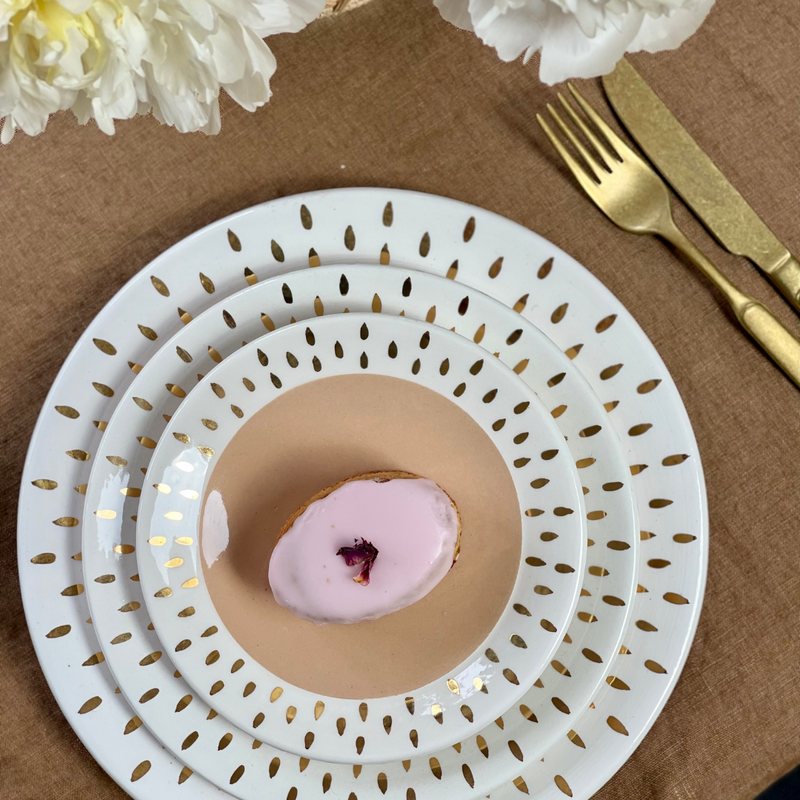 Stacked ceramic dishes by Chabi chic in nude with white and gold rim